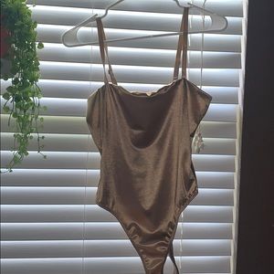 Gold shimmered body suit